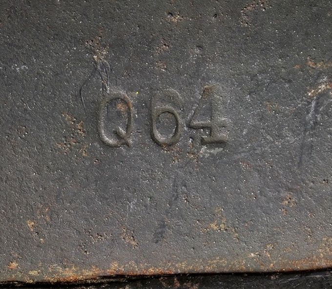 Manufacturing stamp from the Quist factory, Q64. The number 64 represents the number of centimetres around the edge of steel shell. This number can vary from 60 cm to 70 cm (there are some examples known which are even bigger). The Quist factory primarly manufactured M35 and M40 models however an extremely small number of M42s have been observed.