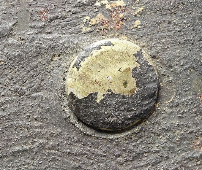 Flat-headed brass rivet with zinc coating.