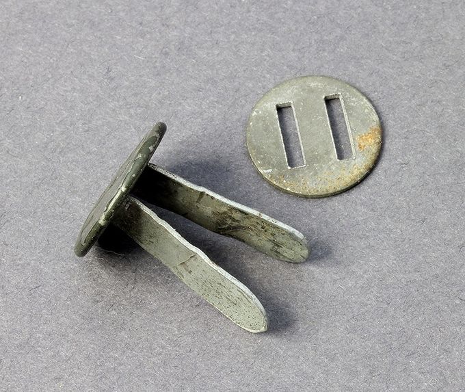 Steel split rivet with zinc coated slotted washer. Unmarked.