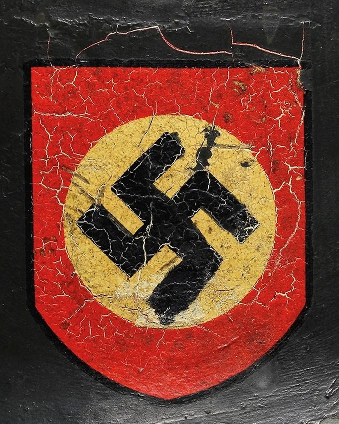 Party shield on the same M35 Quist pictured above. Heavy cracking has been caused by the existence of a second decal underneath the repaint.  It appears that the German soldier had touched up the swastika with black paint. 