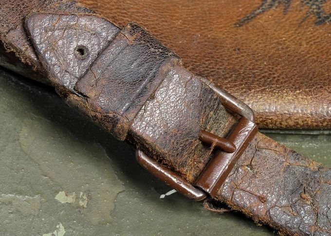 A brown painted early roller buckle on an M18 transitional.