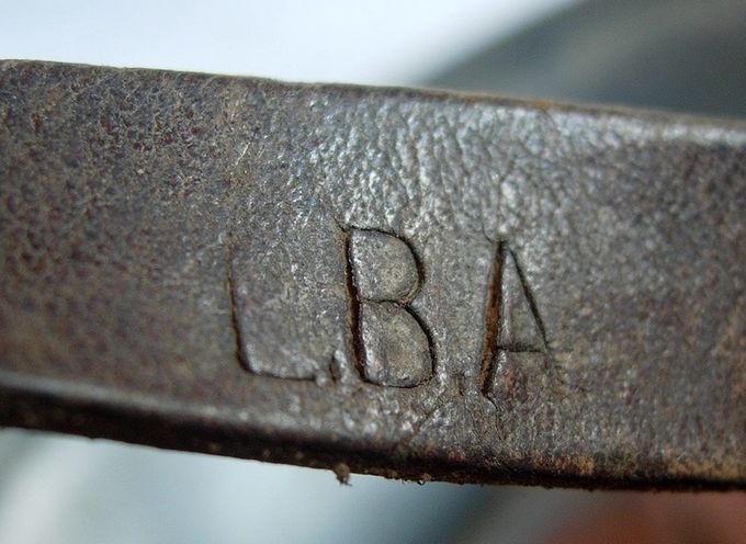 L.B.A. marked chinstrap stamp found on an M35 Luftwaffe helmet. L.B.A. is the abbreviation for Luftwaffebekleidungsamt which means Airforce Clothing Department.