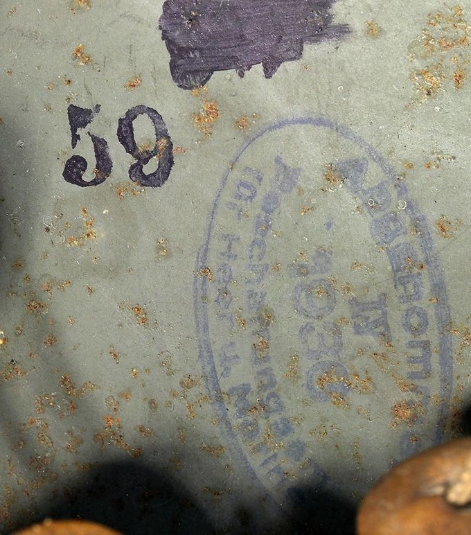 Acceptance stamp in an M35 Quist. Abgenommen IV, 1936, Bekleidungsamt für Heer und Marine. The Roman numeral IV indicates a helmet manufactured in an ET, Quist, SE, NS or EF plant. Notice the size which was initially stamped in error, covered up and then re-stamped “59”.