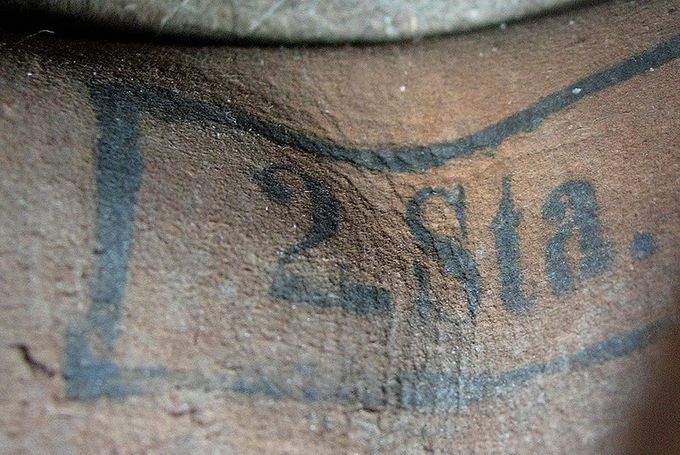 Ink stamp on the inside of a liner of a Luftwaffe helmet. 2. Sta. (Stab) means Staff.