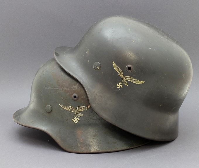 Two M35 LW helmets with smooth paint. To the left an ET and to the right an NS.