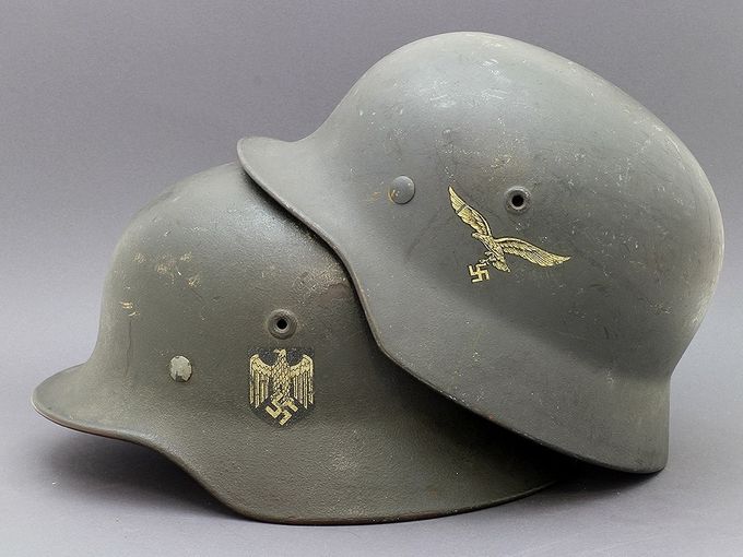 Two M40 Quist helmets with matte textured paint. Notice the difference in paint color between Heer and Luftwaffe.