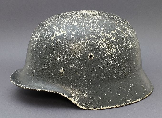 M35 with dark blue paint. Notice the white winter paint underneath the last layer. This is typical of helmets found in Norway due the long winters in the North.