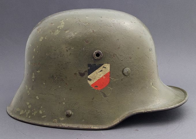 The right side of the M16/M17 above. Notice the slightly smaller national shield compared with national shields on M35s. Visible beneath the cracking is a Weimar decal.
