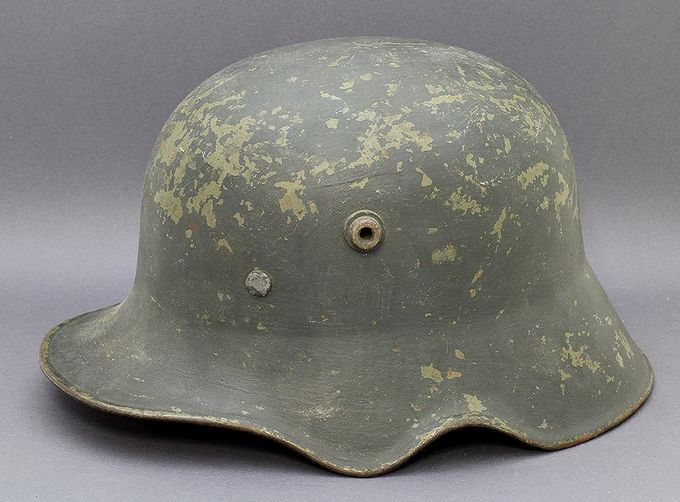 M18 ET64 ear out-cut helmet. The helmet has a Heer decal under the last layer of gray rough-textured paint. Notice the flaking of the textured paint revealing the smooth early green transitional paint underneath.