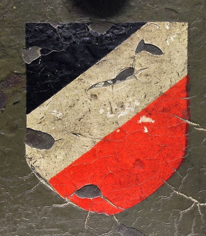 The national shield on the same M16 transitional shown in the picture above. This shield is an early version and it is slightly smaller than the national shield which came later in the late 1930s. Notice the cracking due to the Reichswehr decal beneath the last paint layer.  