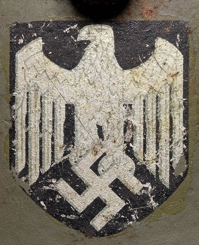 Heer decal on an M16/M17 Austrian transitional helmet.The Heer decal is a Huber Jordan & Koerner type with faint, almost blurred lines in the eagle itself. 