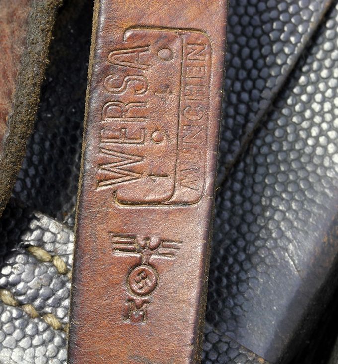 A Kriegsmarine (Navy) marking on a Y-strap. The KM marking is pictured with an eagle with swastika on top of capital letter 