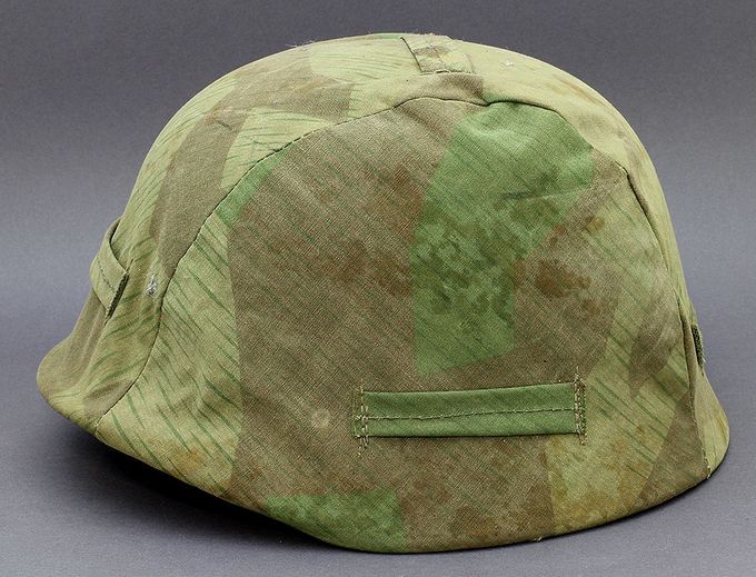 M40 Q62 with a field/depot-made splinter pattern cover. The details have faded due to age and wear. 