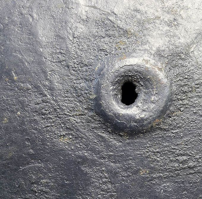 The paint structure of the M40 helmet above. The vent hole is almost covered with the thick textured paint.