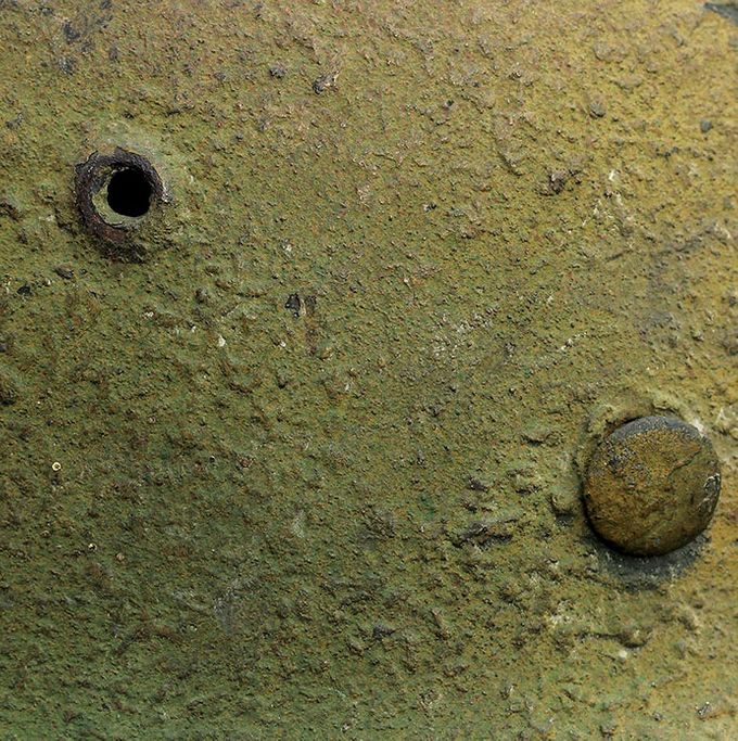 The paint structure of the M35 helmet above. Notice the rough textured paint with woodchips and sawdust.