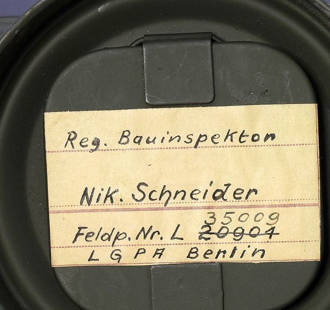 Naming on the inside of the cover of a gas mask canister. 